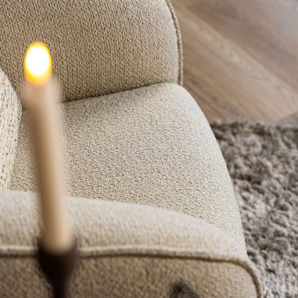 Lio armchair with a curved silhouette and soft upholstery, designed for modern and elegant living interiors.