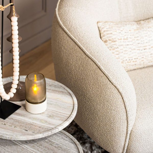 Lio armchair with a curved silhouette and soft upholstery, designed for modern and elegant living interiors.