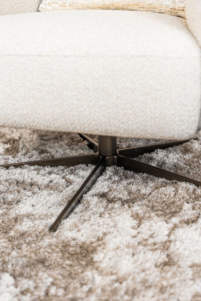Lio armchair with a curved silhouette and soft upholstery, designed for modern and elegant living interiors.