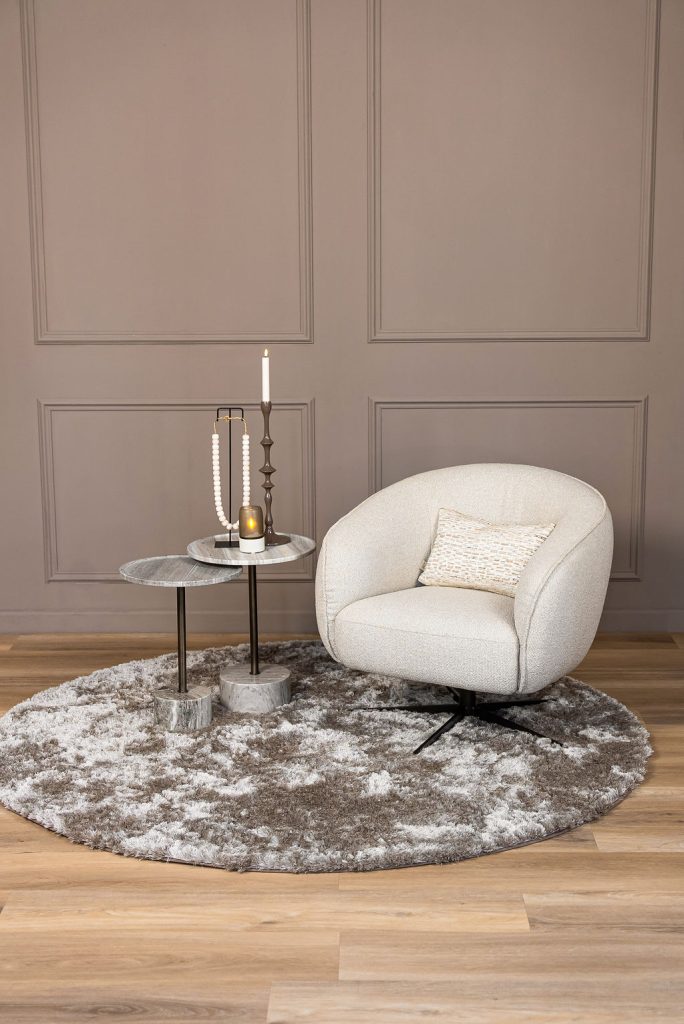 Lio armchair with a curved silhouette and soft upholstery, designed for modern and elegant living interiors.